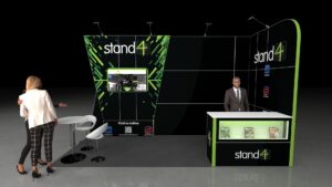 5x2 metre modular exhibition stand. The stand features a large graphic back wall with a mounted screen showing video content, a dedicated white reception counter with under-counter display shelving, and a small white high table with two stools used as a casual meeting area.