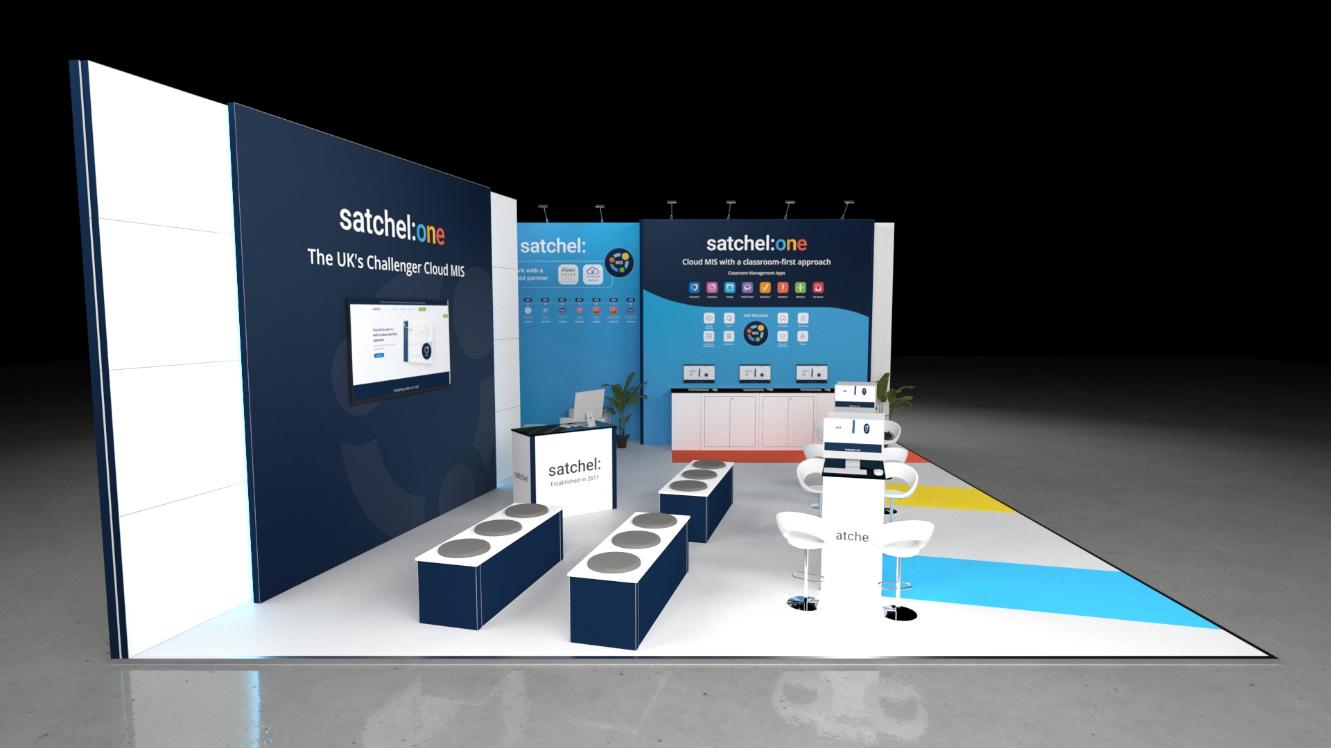 Modern exhibition stand with multiple counters, seating areas, digital screens, and informational wall displays in a clean, open layout designed for product demonstrations and visitor engagement