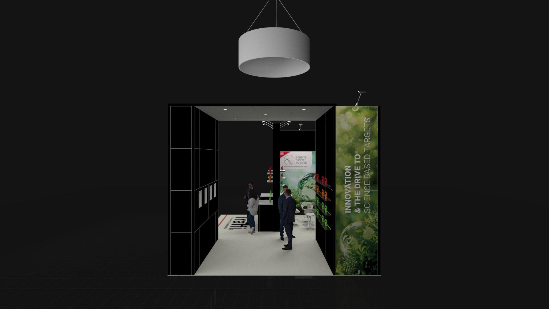 Modern exhibition stand with tall panels, glove displays, floor graphics, and a large circular hanging light above. Several people are interacting around the booth.